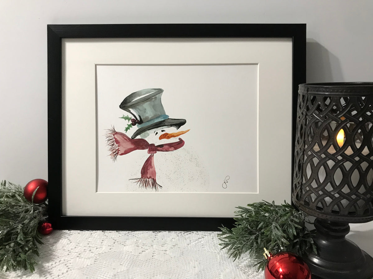 Framed silhouette snowman artwork with top hat, scarf, and glitter accents
