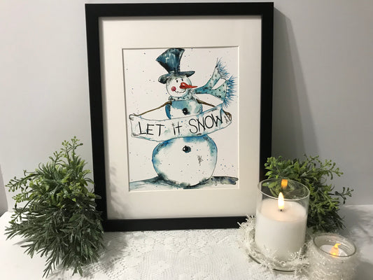 Framed snowman wall art with blue figure wearing a hat and 'LET IT SNOW' text