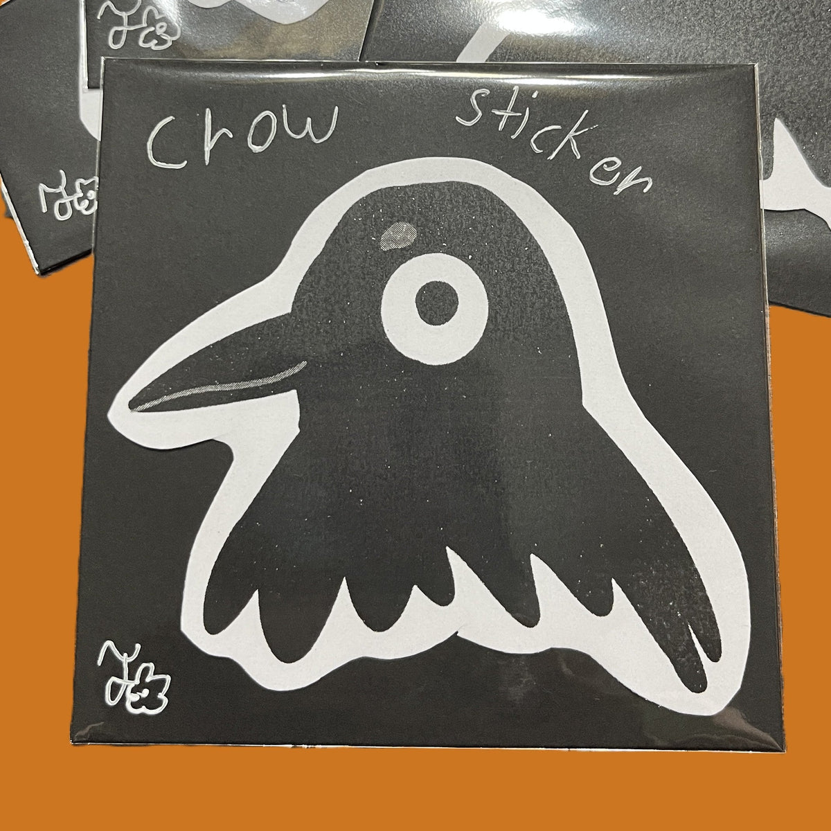 Handmade crow sticker with bold black-and-white illustrated bird head