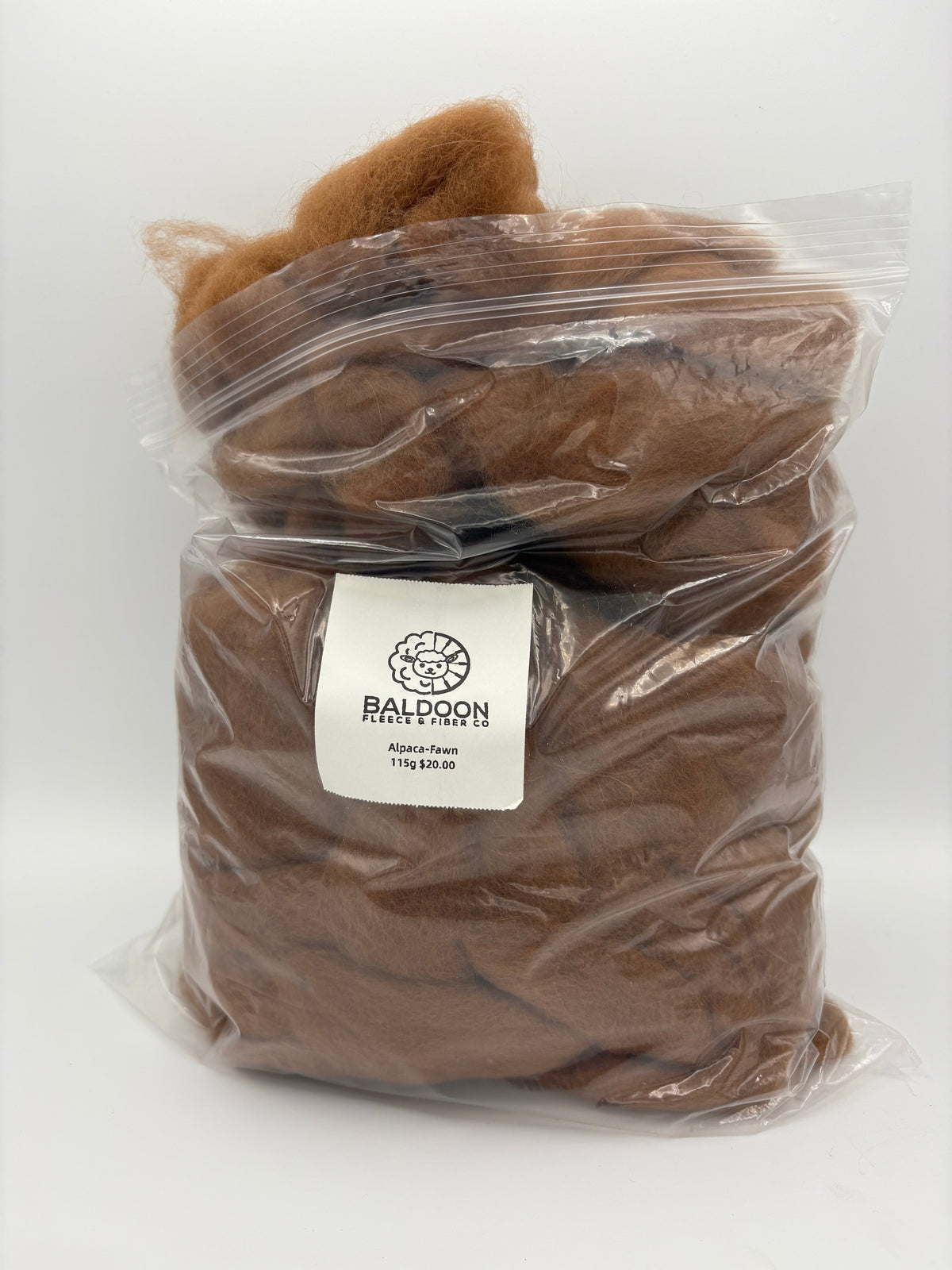 Brown alpaca roving in clear plastic bag with BALDOON label