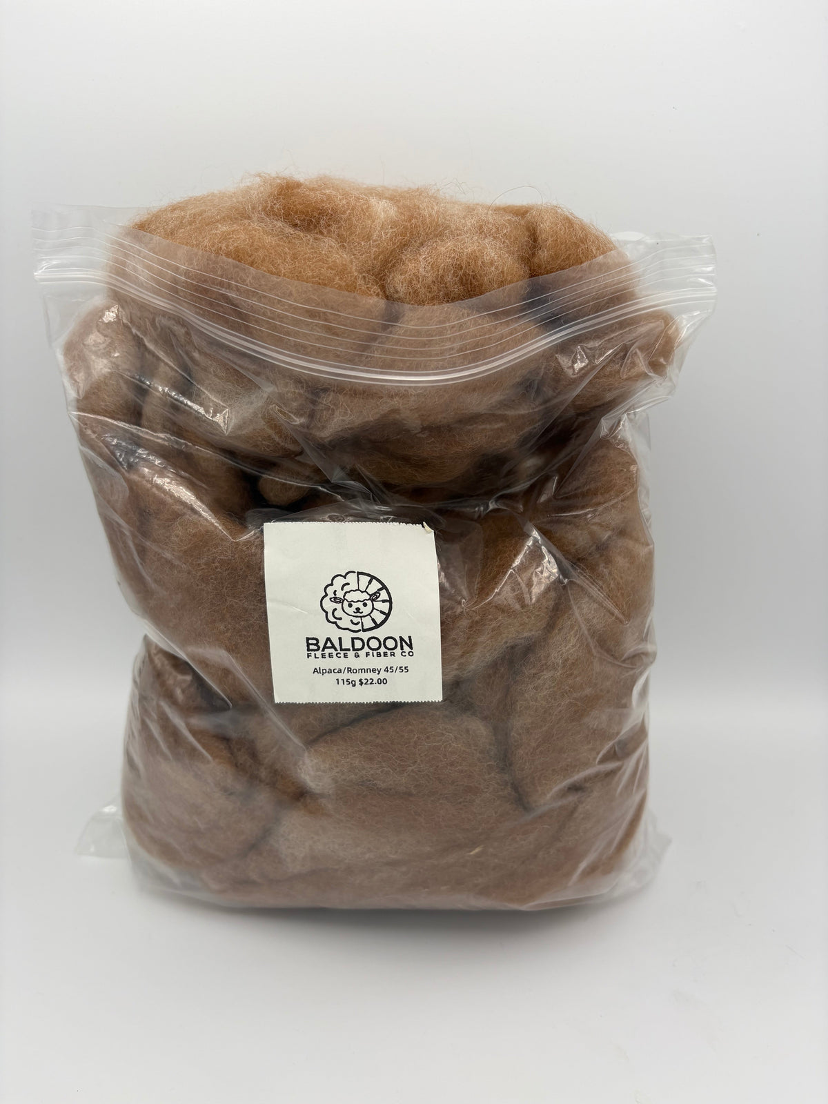 Alpaca roving fiber in clear bag, tan-brown, with Baldoon label