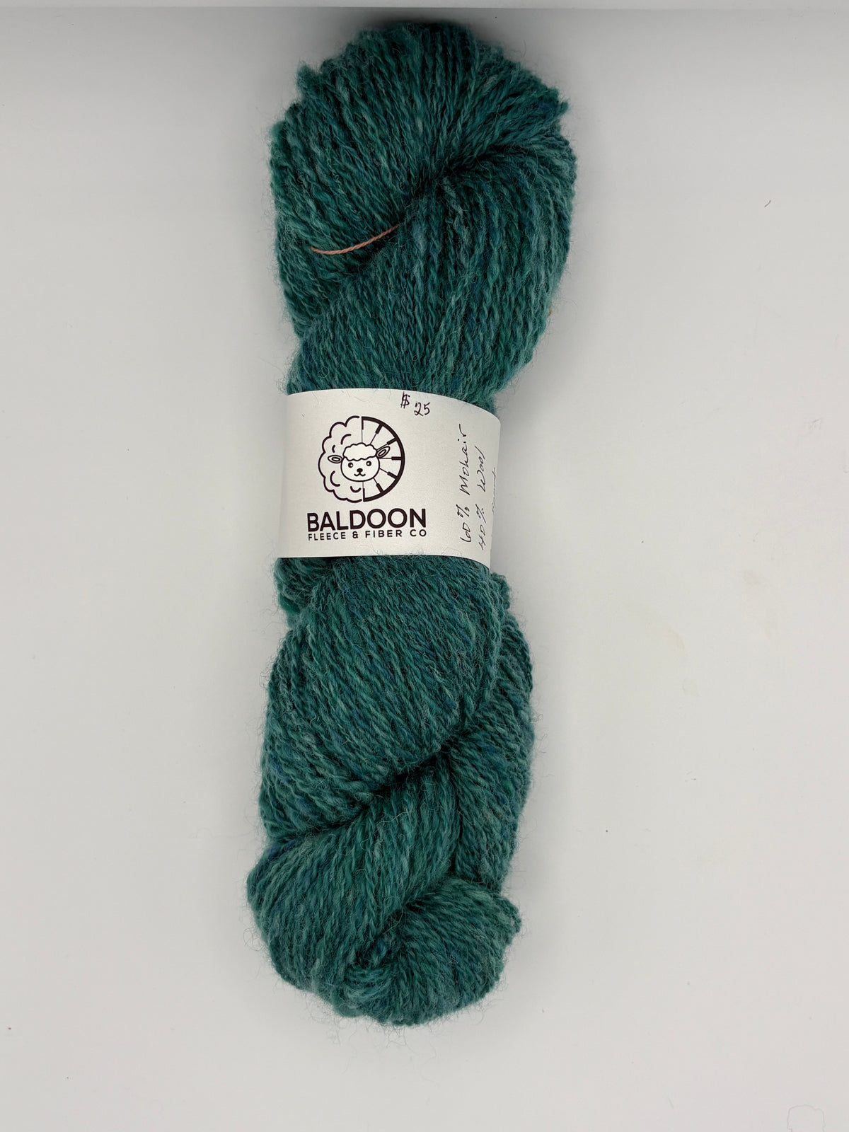 Teal handspun wool yarn skein with BALDOON label