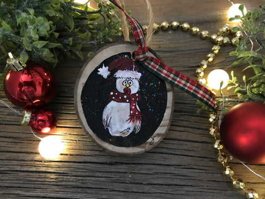 Round wooden chicken ornament with painted hen on dark circle, plaid ribbon loop