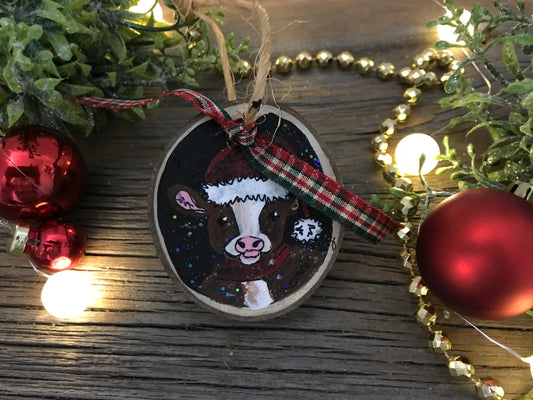 Hand-painted wooden cow ornament with plaid ribbon and painted cow face