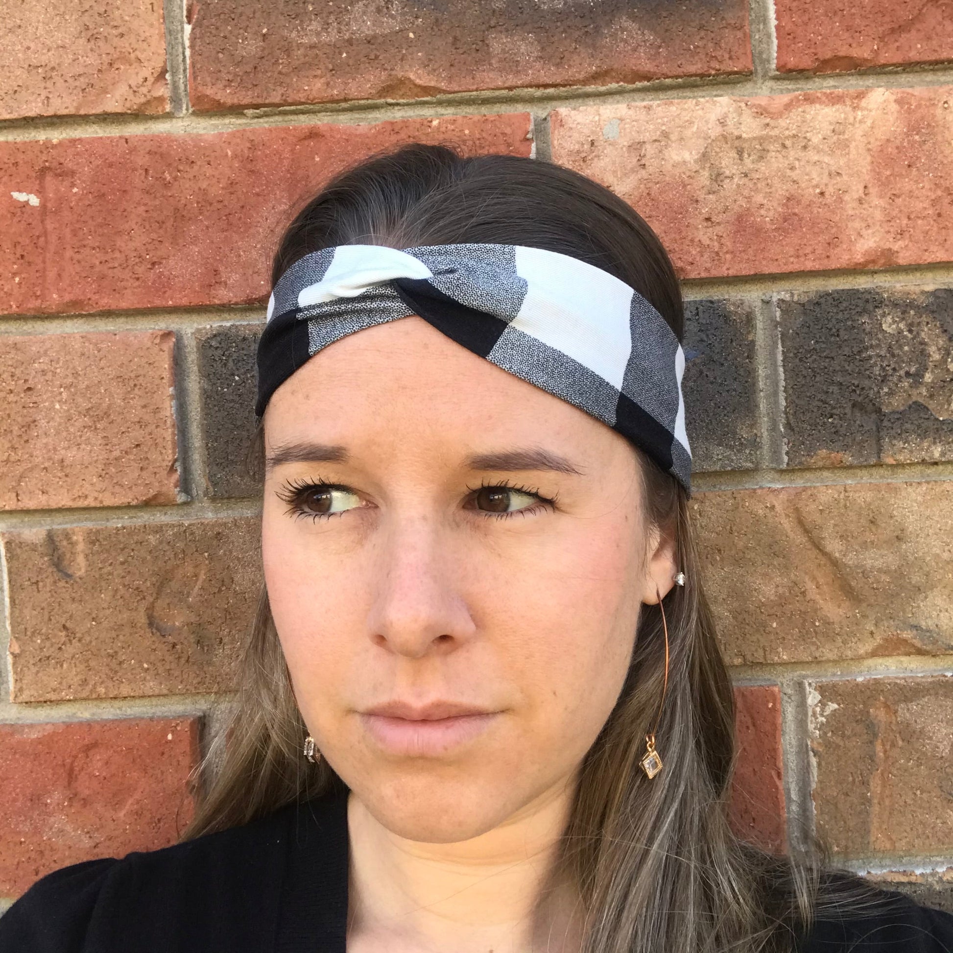 Black and white plaid twist bamboo headband with knotted center, close-up