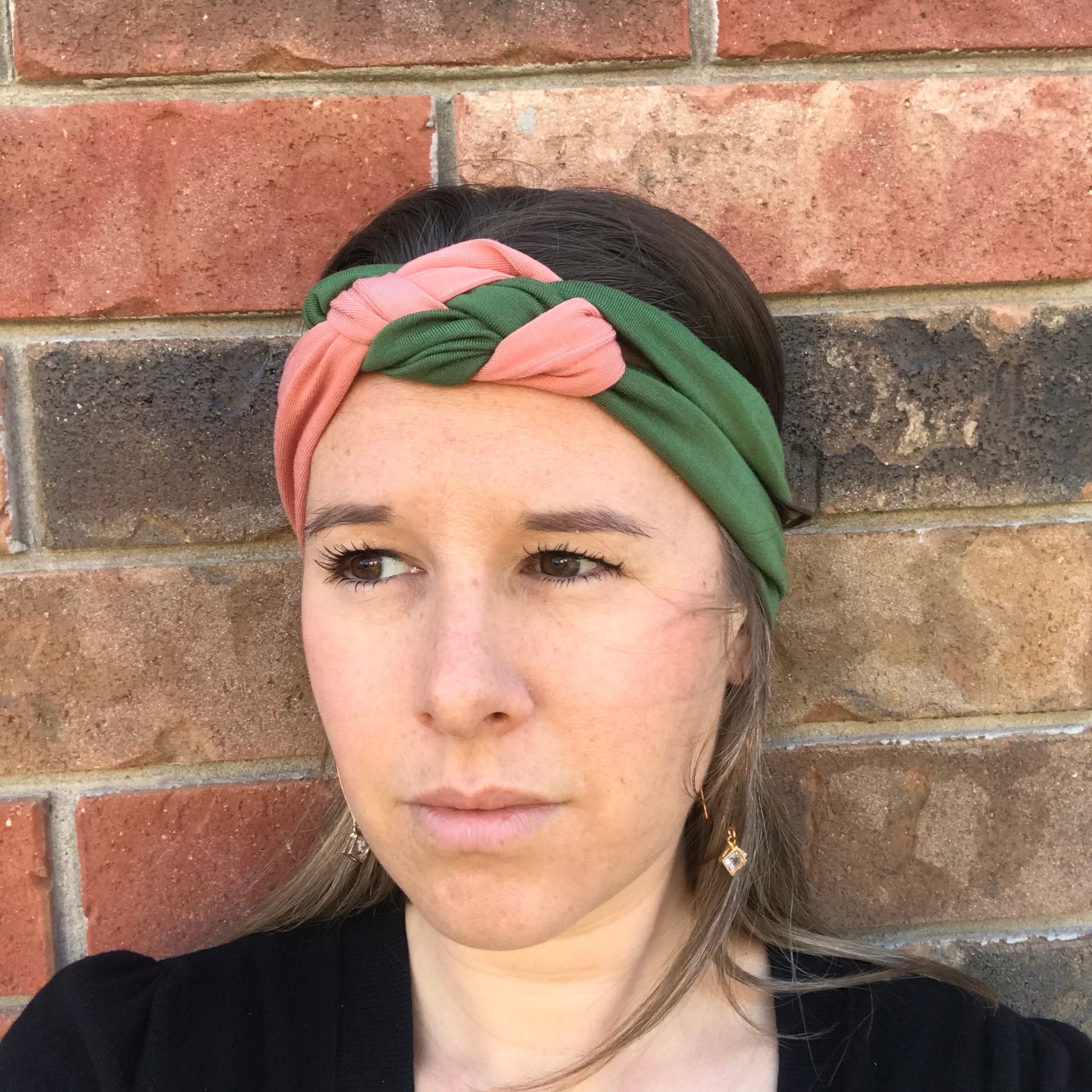 Knot headband in green with pink coral twist across the front knot