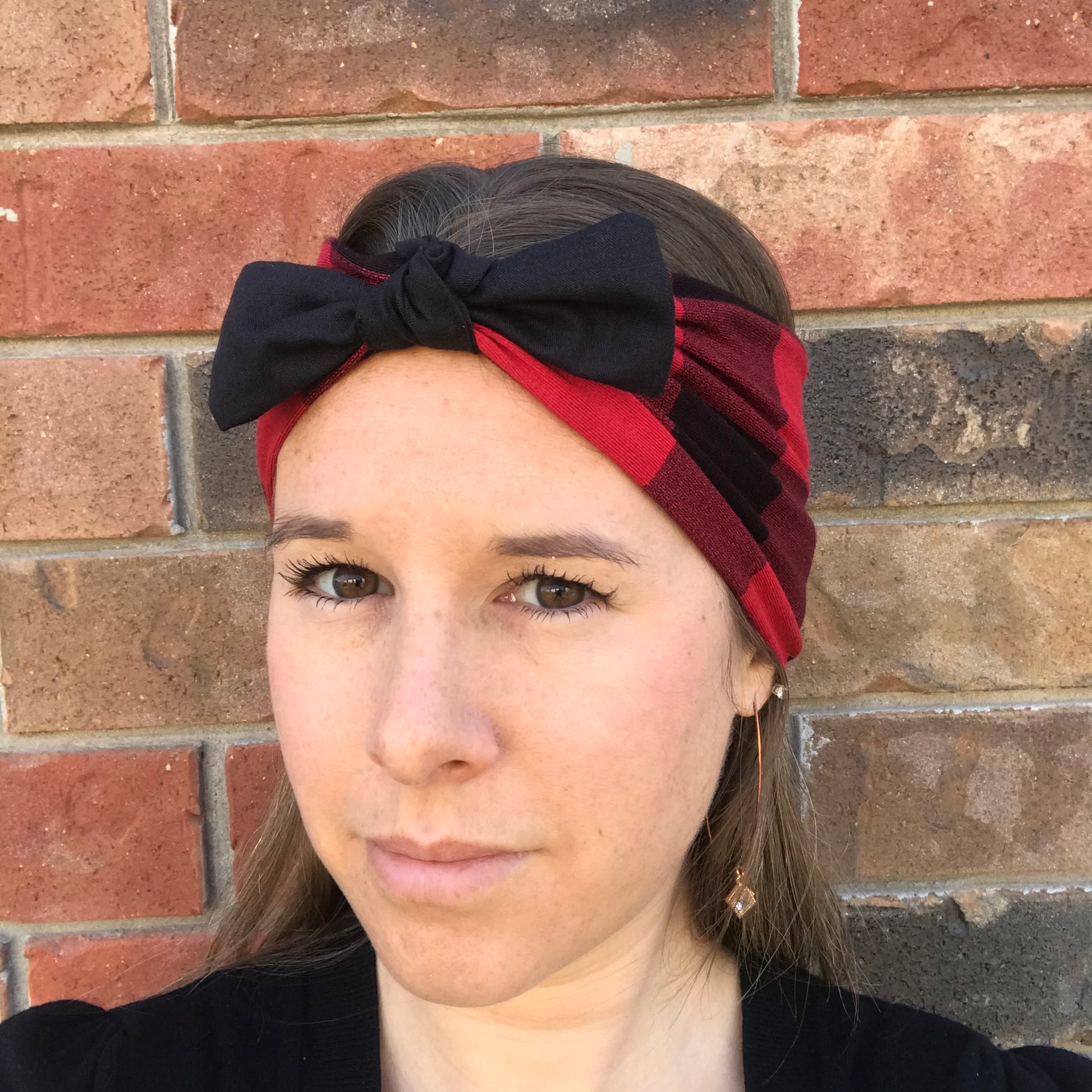 Red and black striped bow headband with large black bow at the front