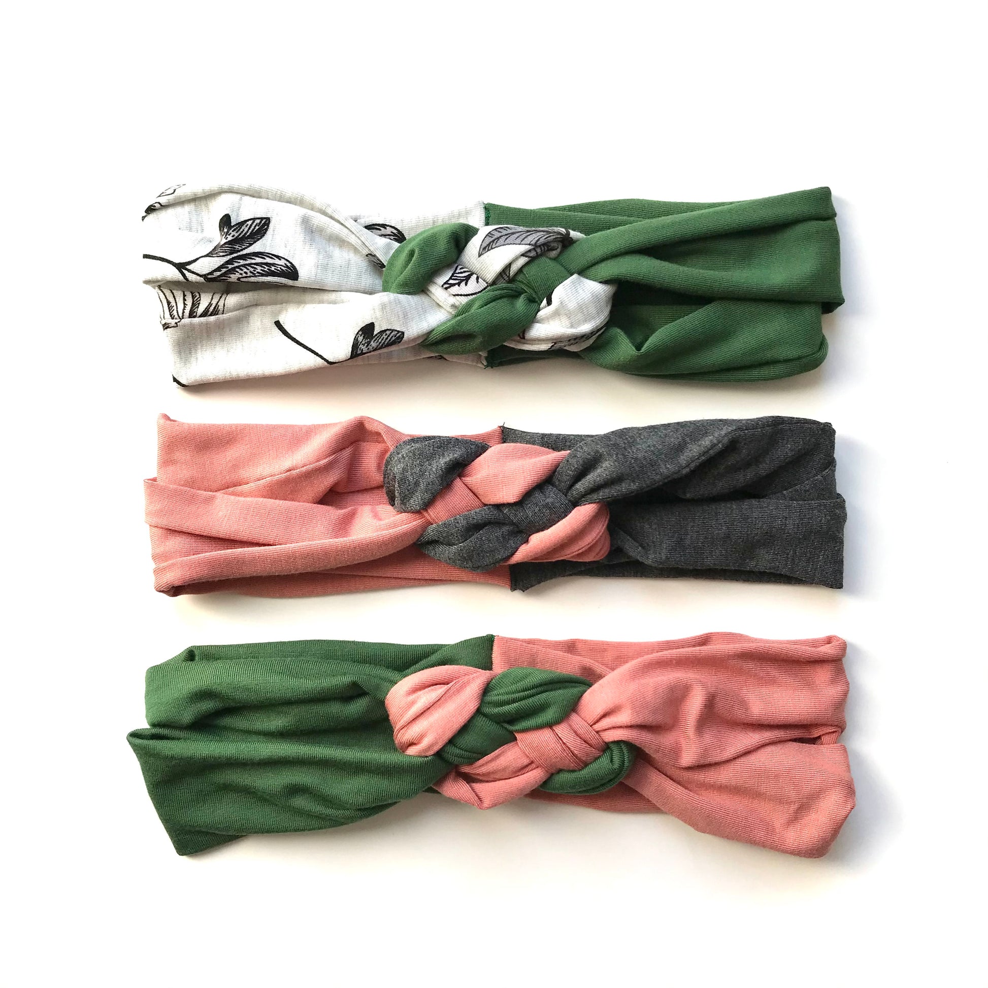 Knot headbands set with green, white patterned, coral, pink, and charcoal designs
