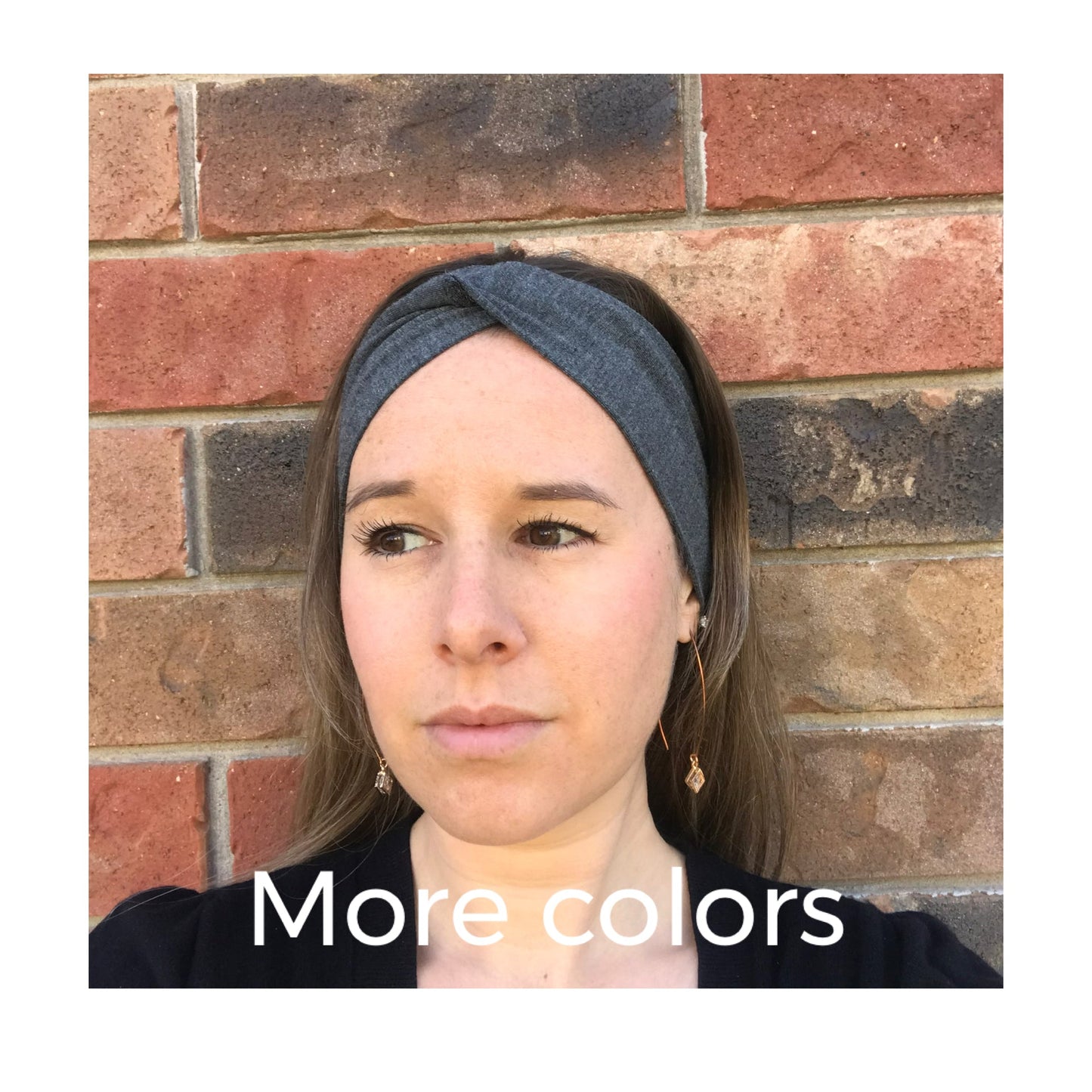 Twist fabric headband in dark gray, worn across the forehead.