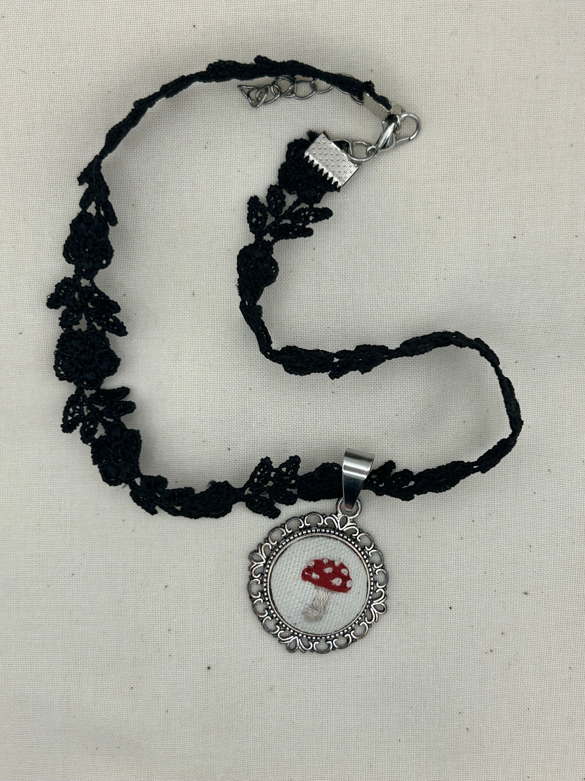 Black embroidered choker necklace with lobster clasp and round Amanita mushroom pendant