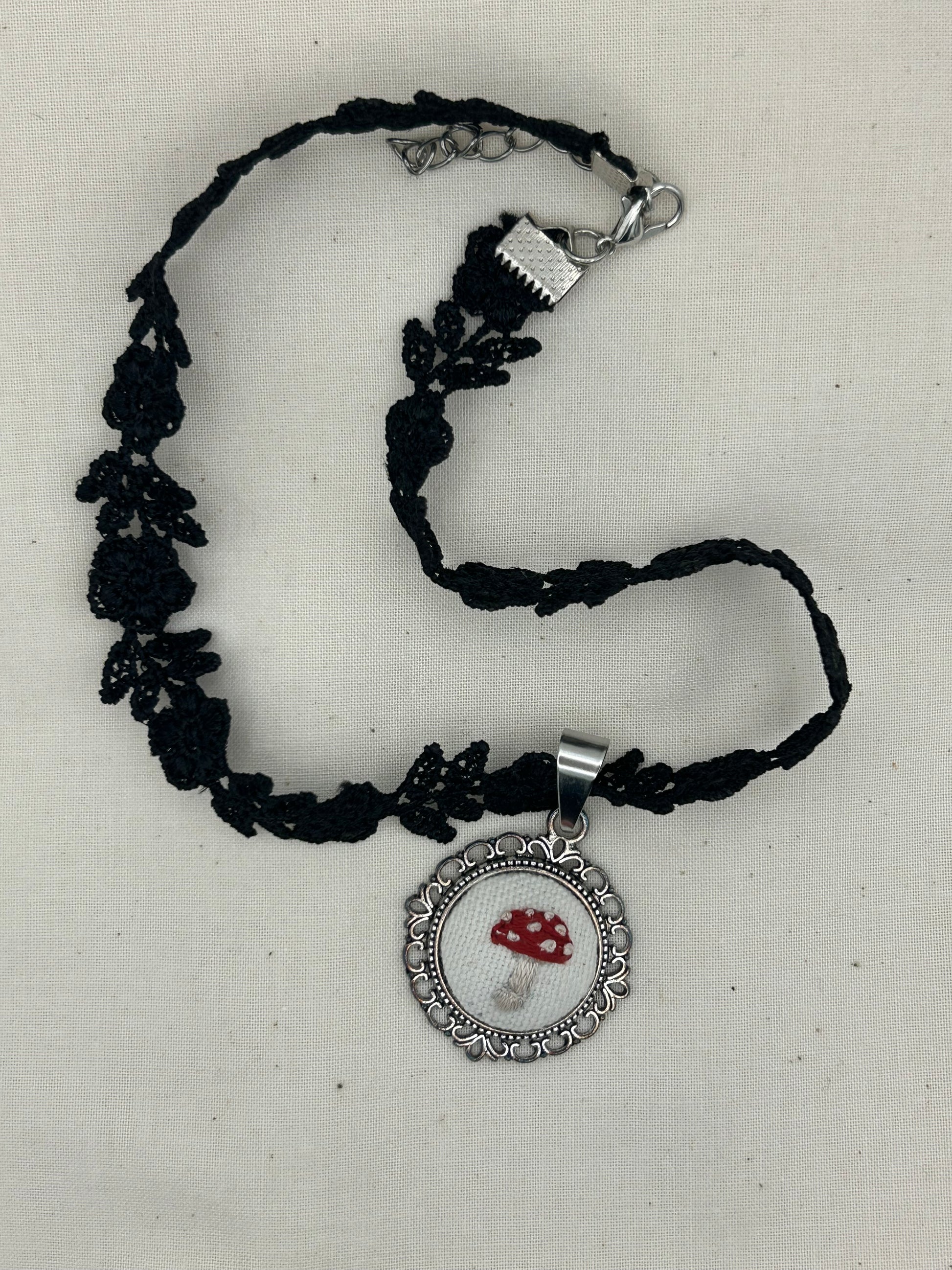 Black embroidered choker necklace with lobster clasp and round Amanita mushroom pendant