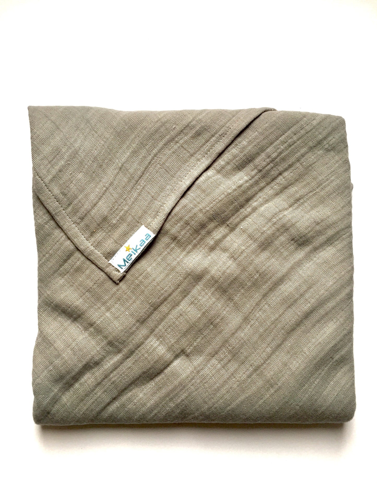 Light gray swaddle blanket with stitched corner and Meikaa tag