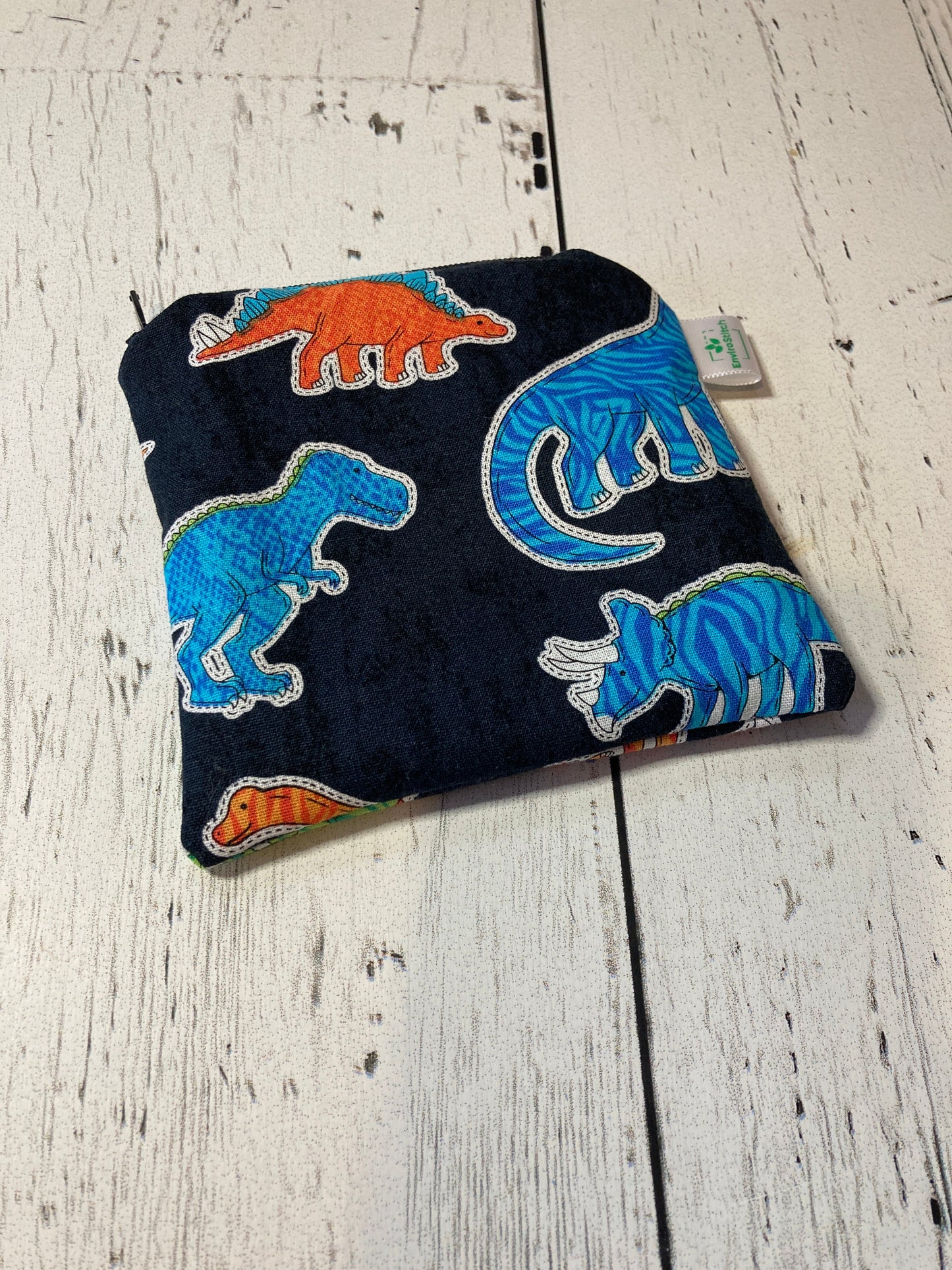 Dark navy dinosaur snack bag with colorful dinosaur appliques