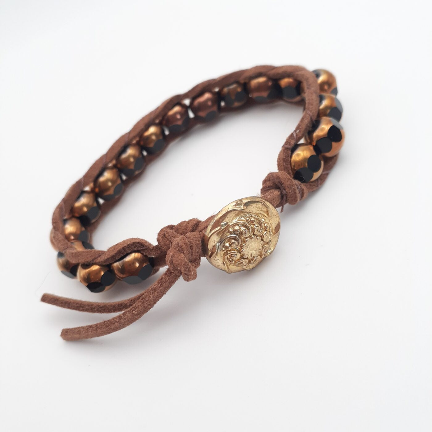 Brown suede leather bracelet with gold and brown chunky glass beads and a gold button closure