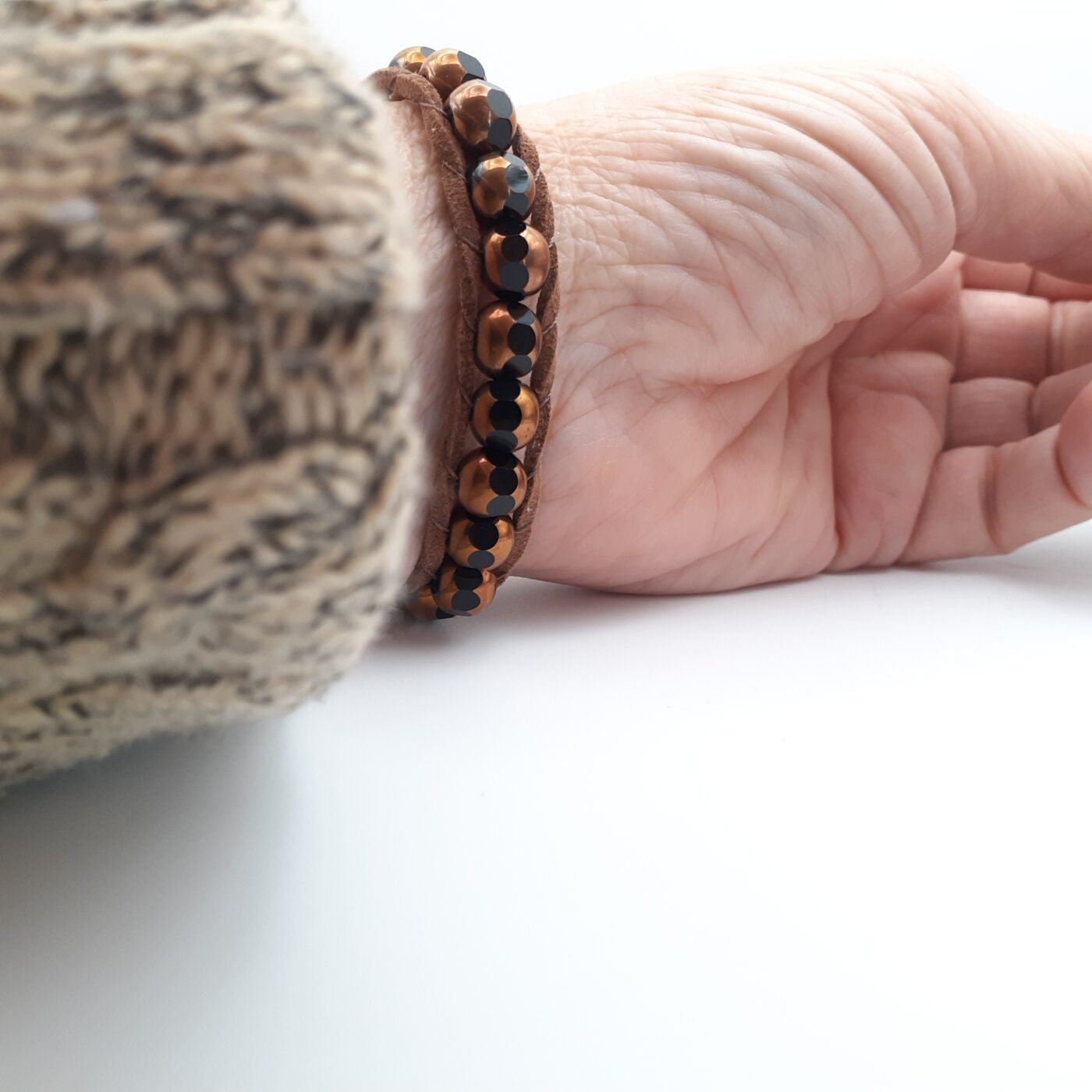 Brown suede leather bracelet with gold and brown chunky glass beads and a gold button closure