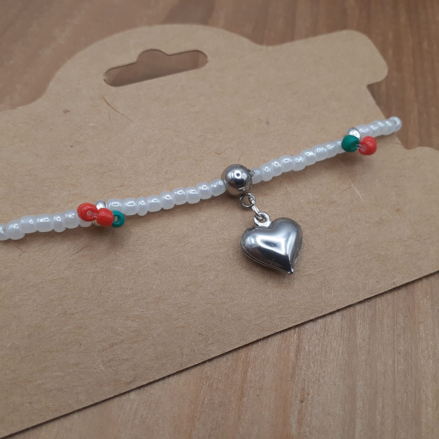 Cherry Love Stretch Bracelet White Seed Beads with Little Red and Green Fruity Accents of Colourful Beads and a Puffy Silver Heart Charm