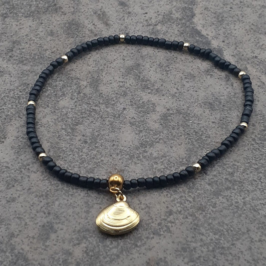 Elegant Black Seed Bead Stretch Anklet with Gold Accent Beads and a Gold 3D Hollow Clam Charm Dangle