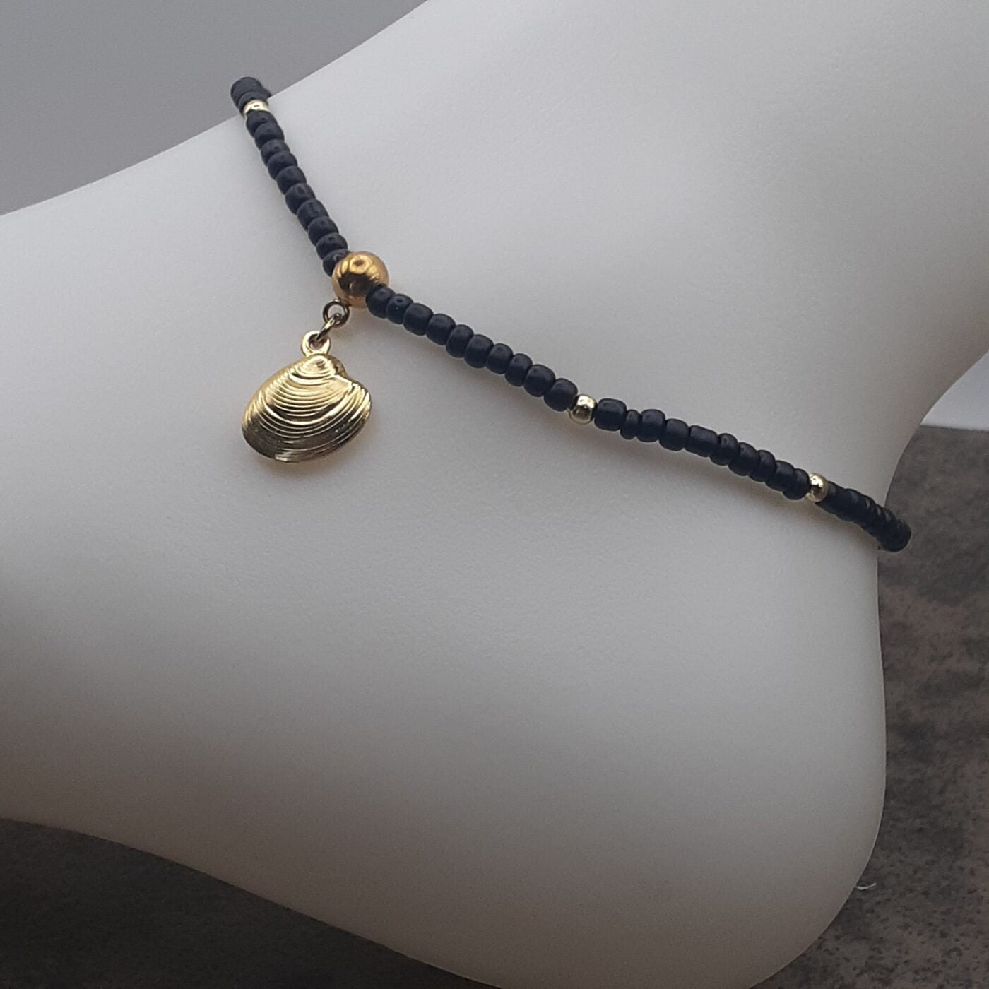 Elegant Black Seed Bead Stretch Anklet with Gold Accent Beads and a Gold 3D Hollow Clam Charm Dangle