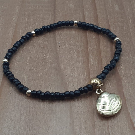 Elegant Black Seed Bead Stretch Bracelet with Gold Accent Beads and a Gold 3D Hollow Clam Charm Dangle