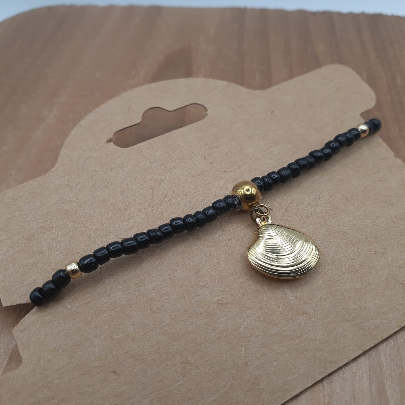 Elegant Black Seed Bead Stretch Bracelet with Gold Accent Beads and a Gold 3D Hollow Clam Charm Dangle