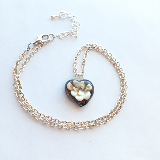 Heart pendant necklace with dark lampwork glass heart and silver chain, clasp visible