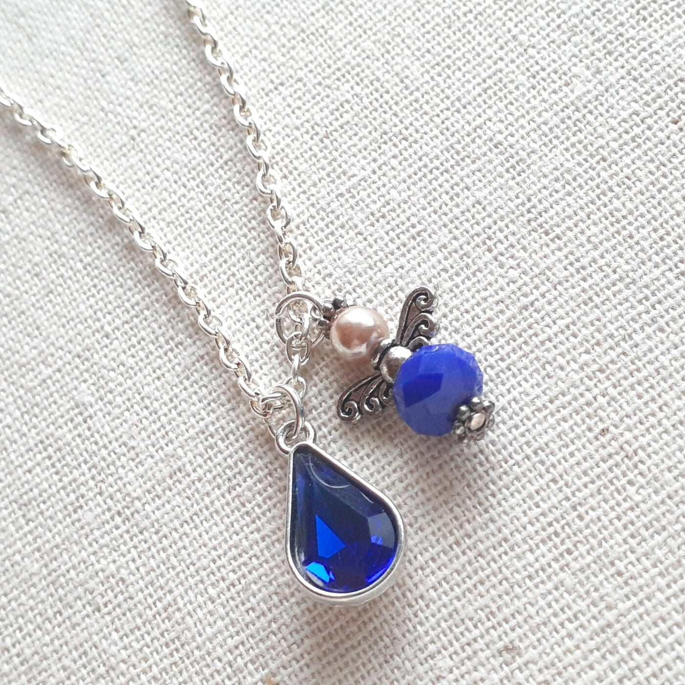 Faceted Opaque Sapphire Blue Czech Crystal and Pearl Guardian Angel Charm with a Blue Crystal Teardrop Charm on a Sterling Silver Thin Chain Necklace