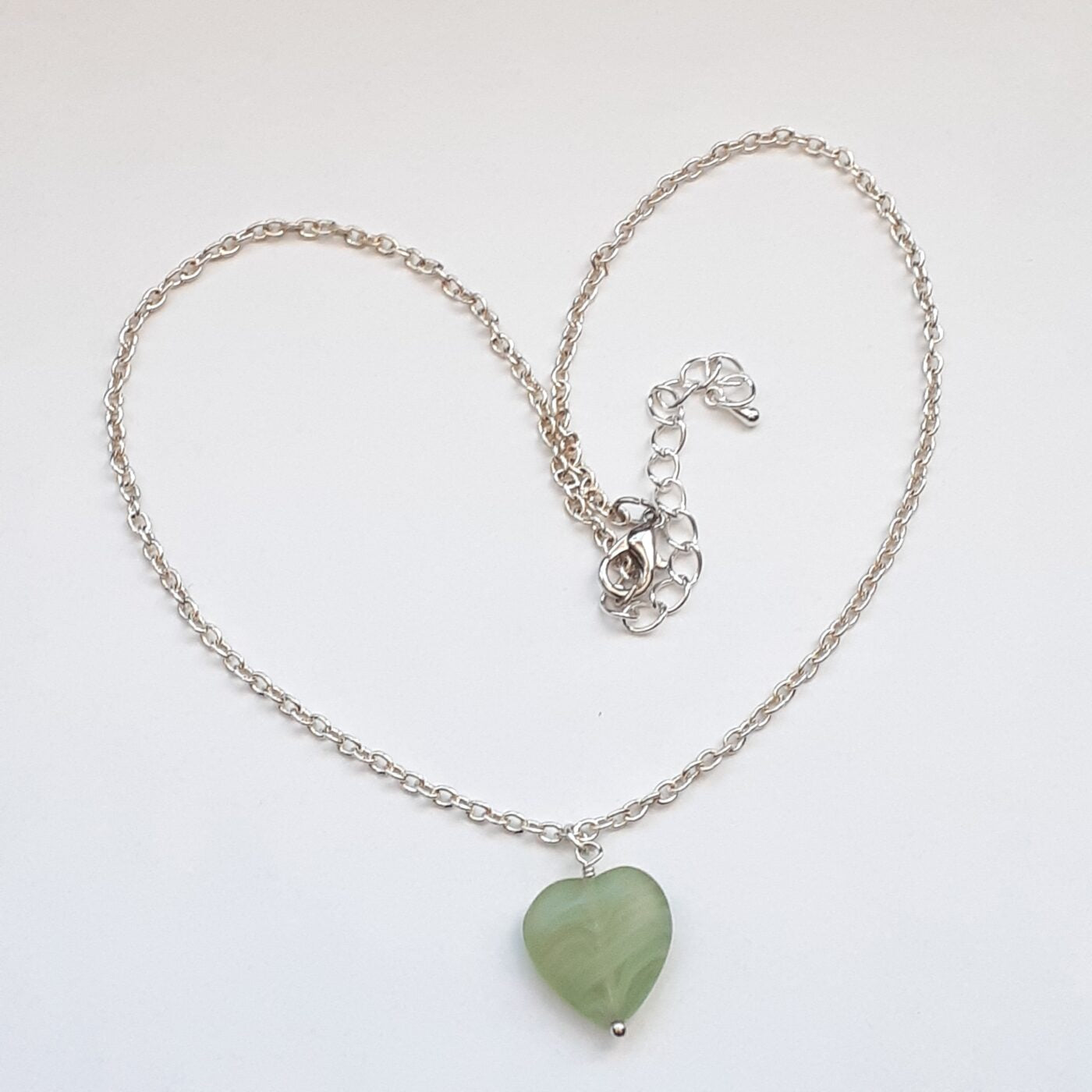Green adventurine heart-shaped stone pendant on a sterling silver chain necklace