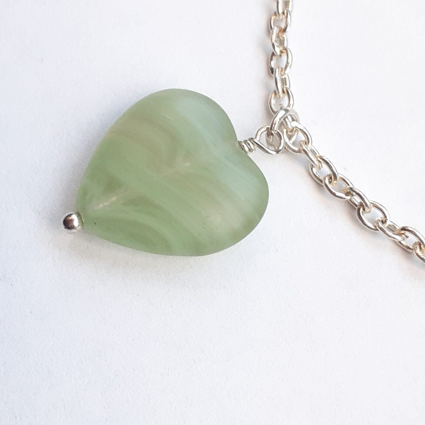 Green adventurine heart-shaped stone pendant on a sterling silver chain necklace