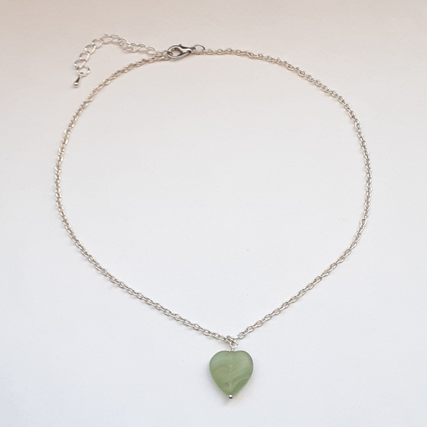 Green adventurine heart-shaped stone pendant on a sterling silver chain necklace