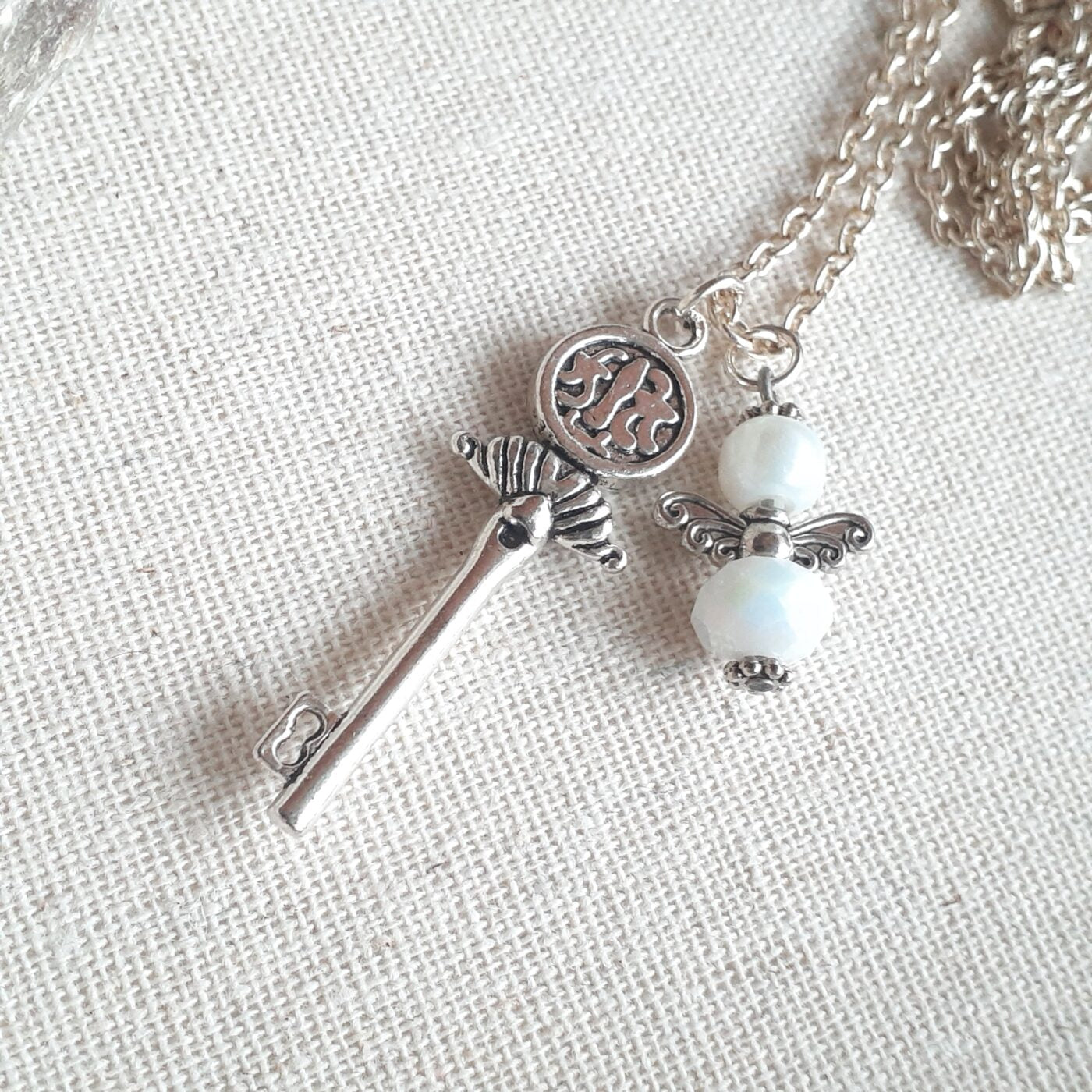 Opaque White Faceted Czech Crystal and Pearl Tiny Guardian Angel Charm and Tibetan Silver 3D Key Charm on a Sterling Silver Necklace Chain