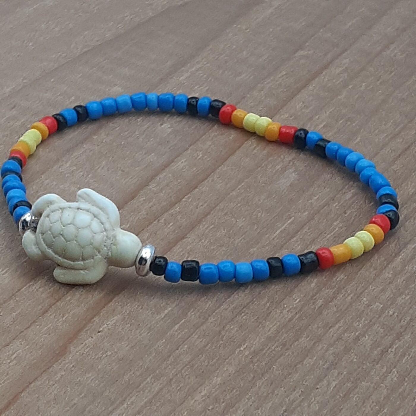 Seaturtle Sensation Colourful Seed Bead Bracelet in Bands of Blues, Sunny Yellows, Reds, and Black