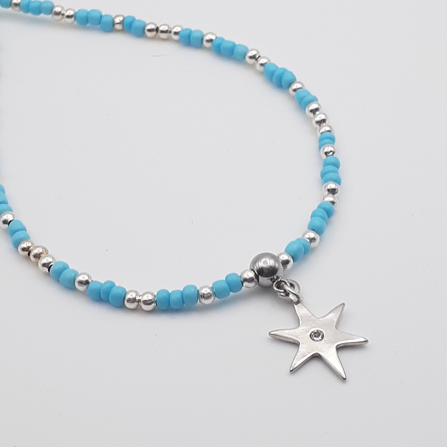 Shining Star Burst Silver Charm Blue Seed Bead Medium Length Necklace