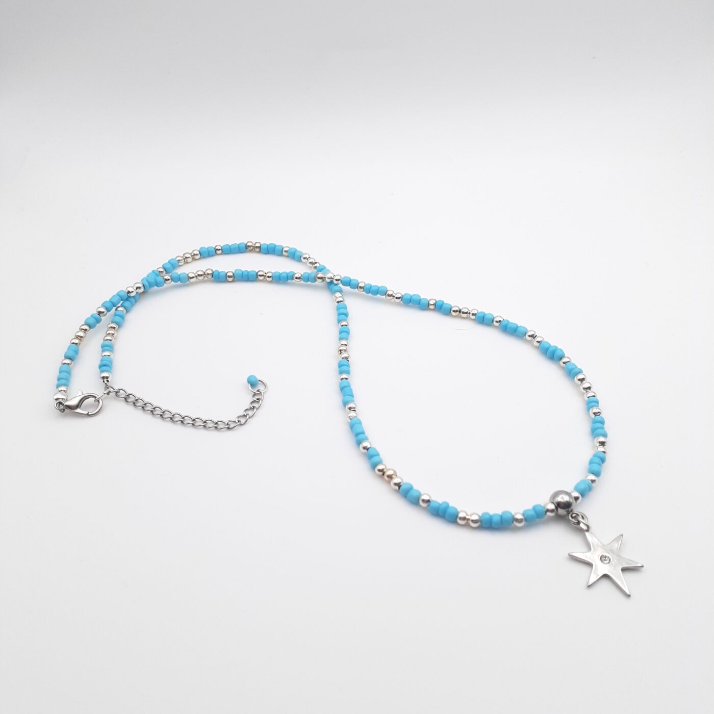 Shining Star Burst Silver Charm Blue Seed Bead Medium Length Necklace