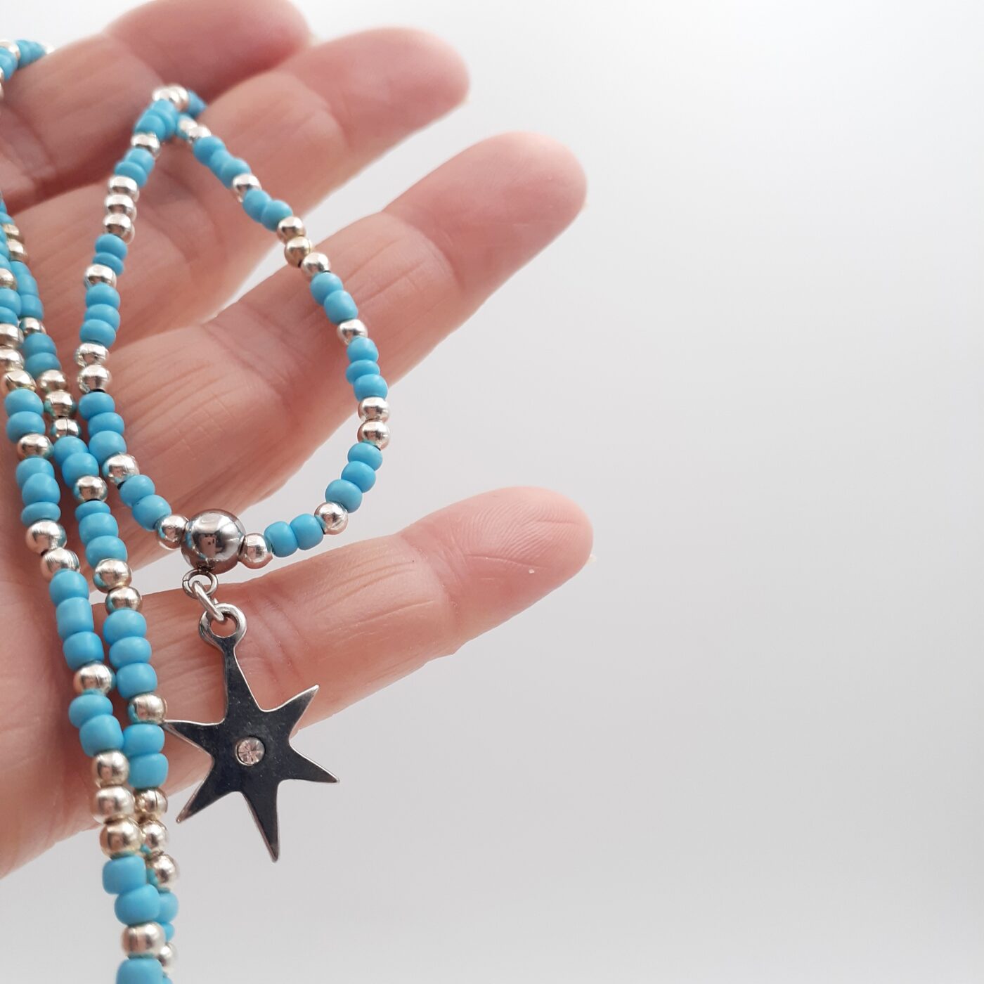 Shining Star Burst Silver Charm Blue Seed Bead Medium Length Necklace