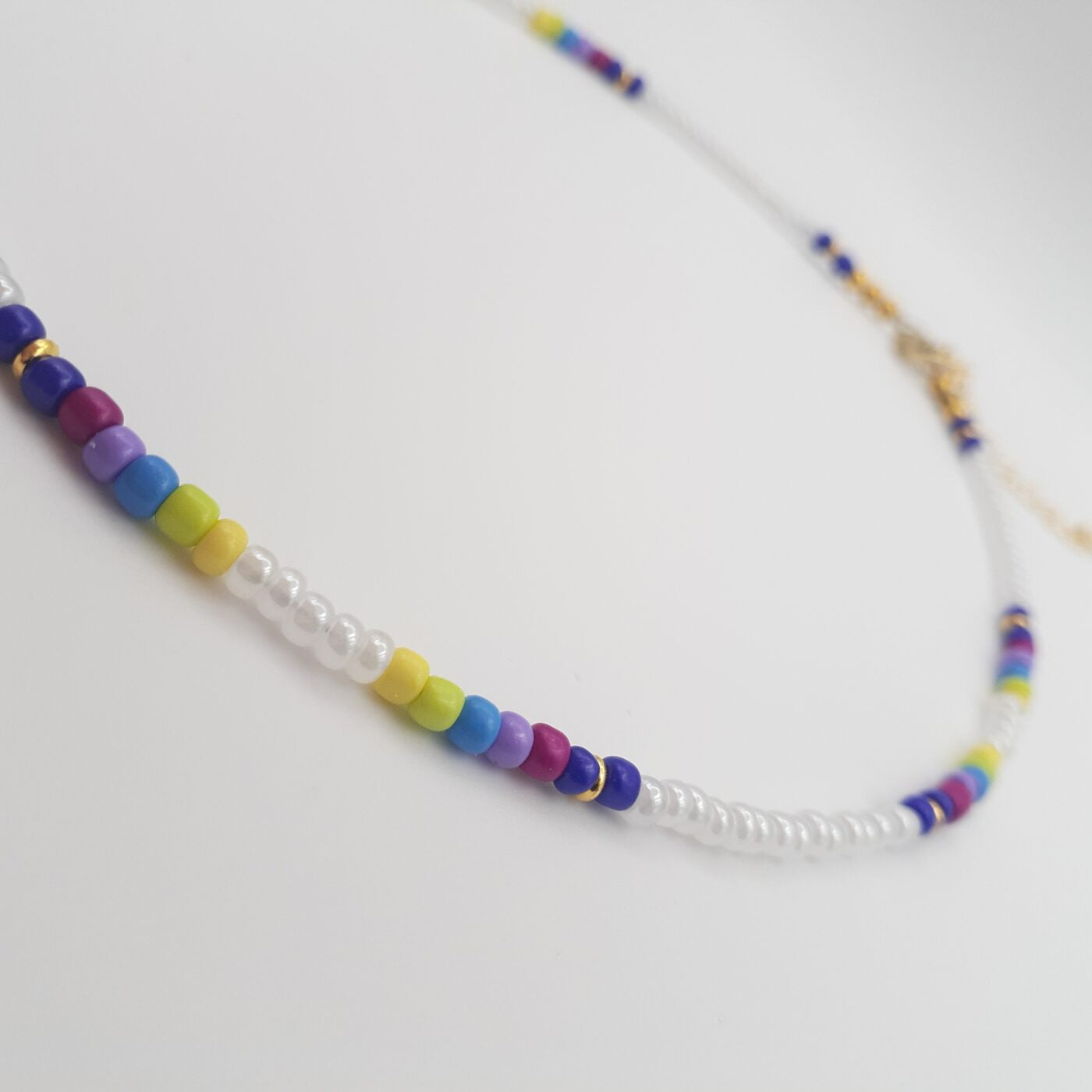 Short White Seed Bead Necklace with Splashes of Vibrant Colour Bands