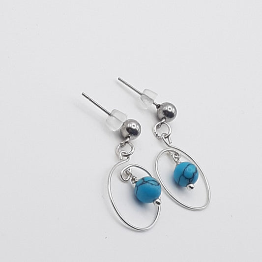 Tiny hoop post-style earrings in a swirl design with blue howlite turquoise beads
