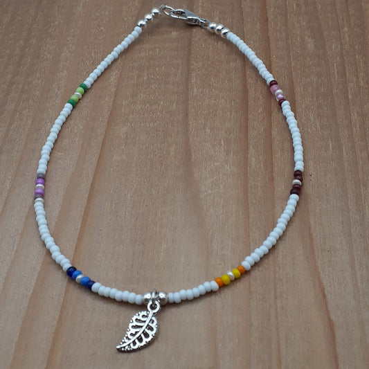 White Seed Bead Anklet with Patches of Vibrant Multi-Colours and a Tiny Detailed Filigree 3D Silver Leaf Charm Dangle