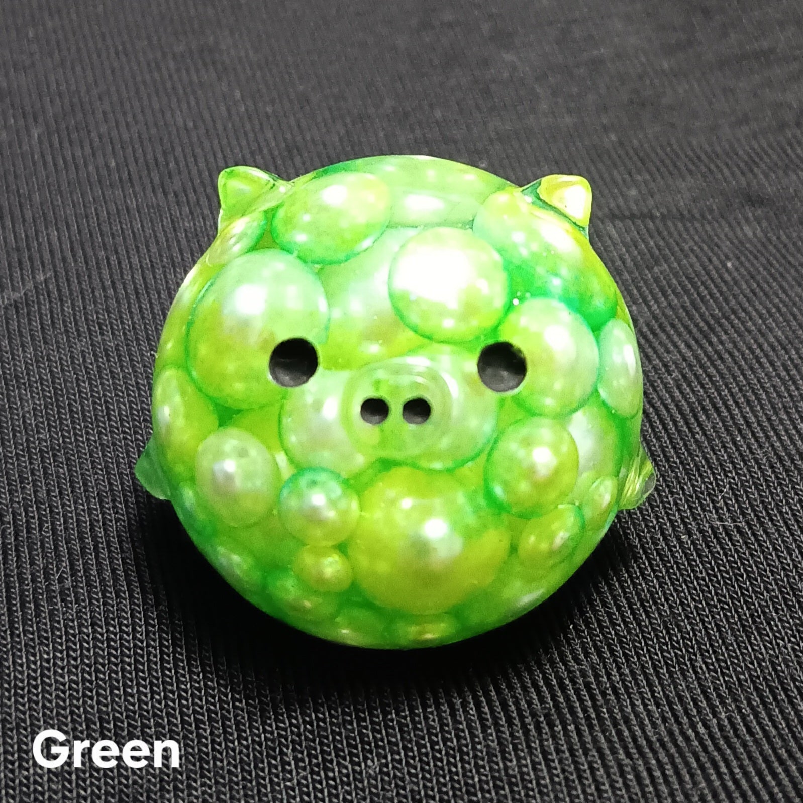 Green mini pig plush with cute face, round ears, and three-button snout detail.