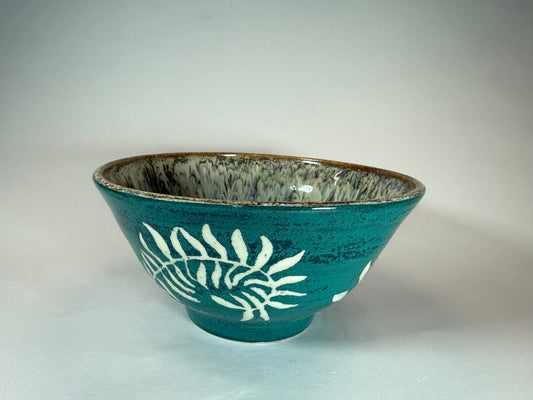 Ceramic bowl in teal with white fern cascade design and brown rim
