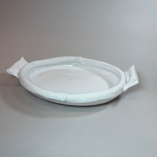 White oval serving tray with raised rim and two side handles