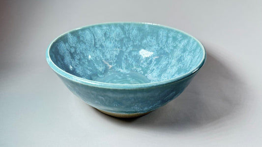 Beach Surf bowl in teal-blue with a textured interior and flared rim