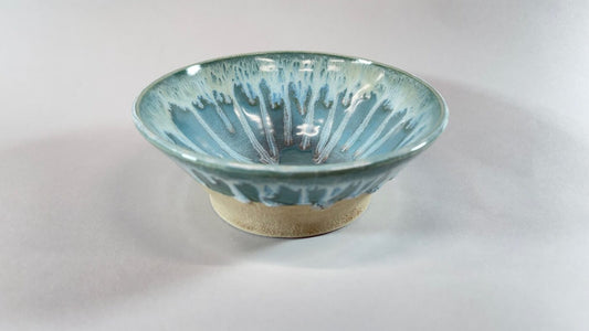 Turquoise ceramic bowl with white stripe pattern and beige base