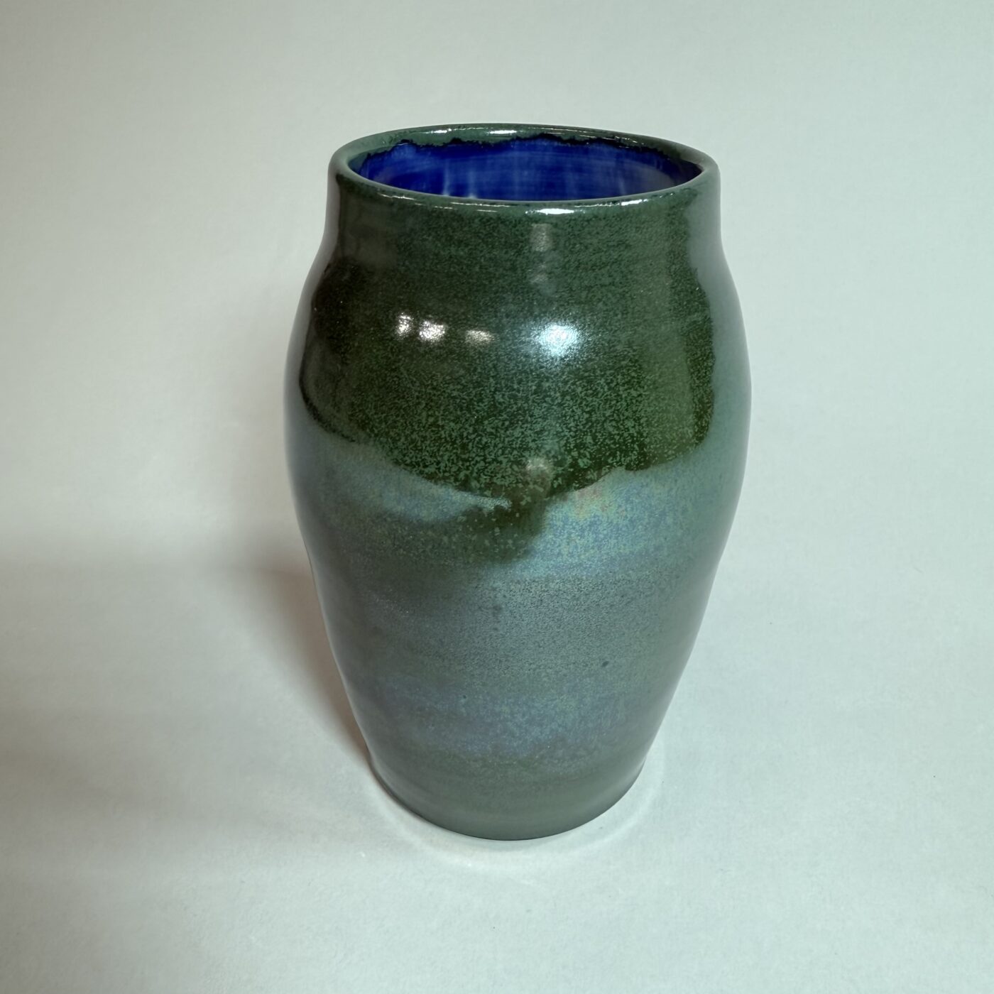 Green ceramic vase with dark rim, rounded belly and glossy glaze