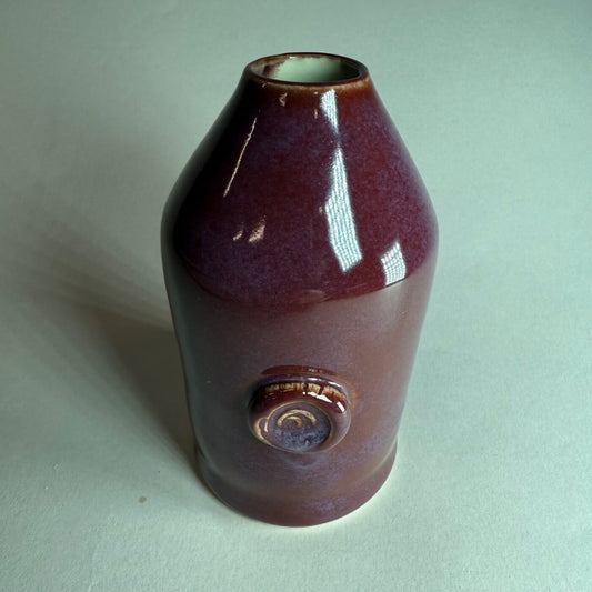 Merlot button-swirl ceramic vase in dark maroon glossy glaze with circular detail near base