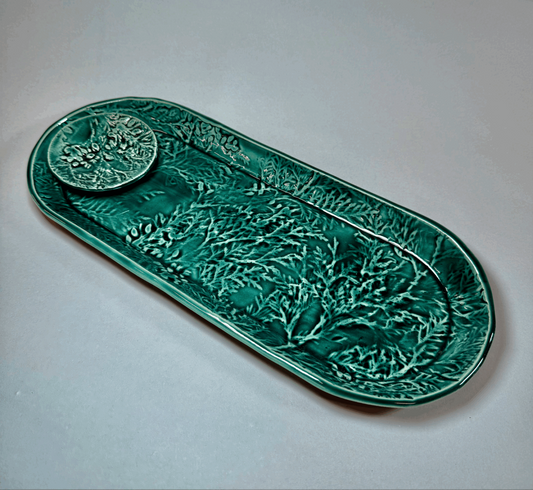 Green oval decorative tray with raised cedar bough pattern