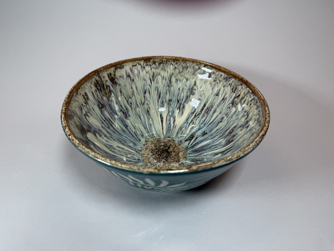 Ceramic bowl teal interior with radial fern pattern, speckled base, brown rim