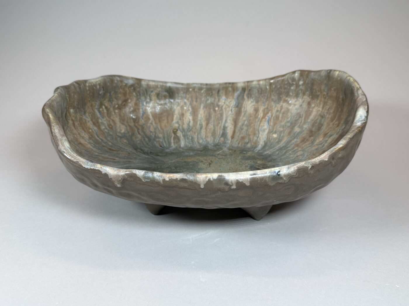 Rustic glazed ceramic serving bowl, oval shape, mottled gray-green finish