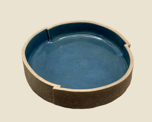 Magma teal stoneware bowl with textured exterior and glossy teal interior