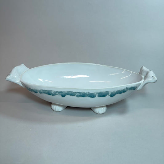 Light blue oval ceramic bowl with glossy finish, side handles, and three pedestal feet