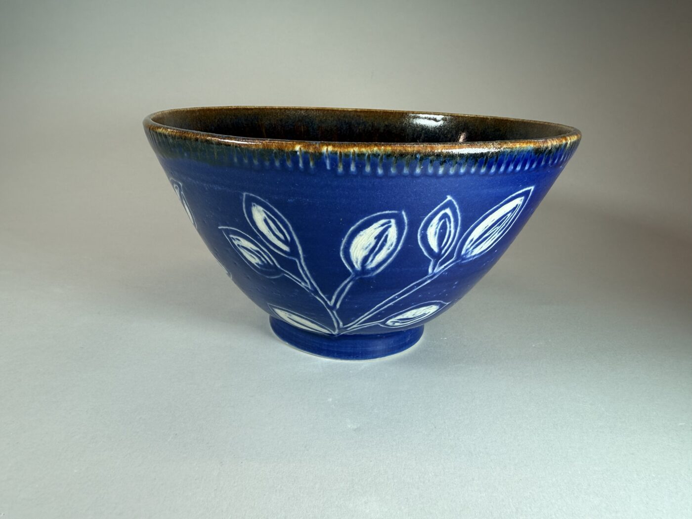 Royal Cascades bowl with blue glaze and white leaf pattern, rounded rim